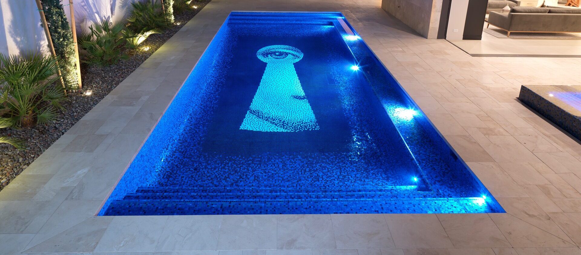 Illuminated custom mosaic pool at night, Las Vegas