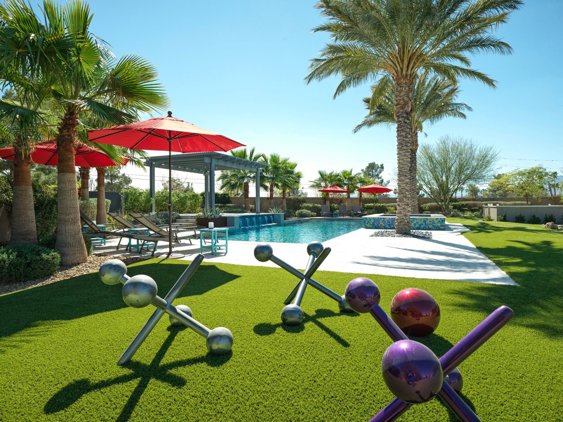 Resort-style pool with palms and glass tile spa